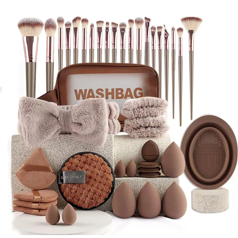 Makeup brush set with washbag, towels, and beauty tools on a white background