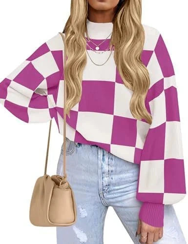 A woman wearing a purple and white checkered long-sleeve sweater, paired with light blue jeans and a beige bucket bag, against a plain white background.