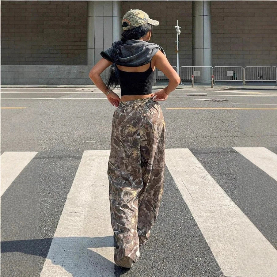 Person wearing camouflage pants and a black top on a city street