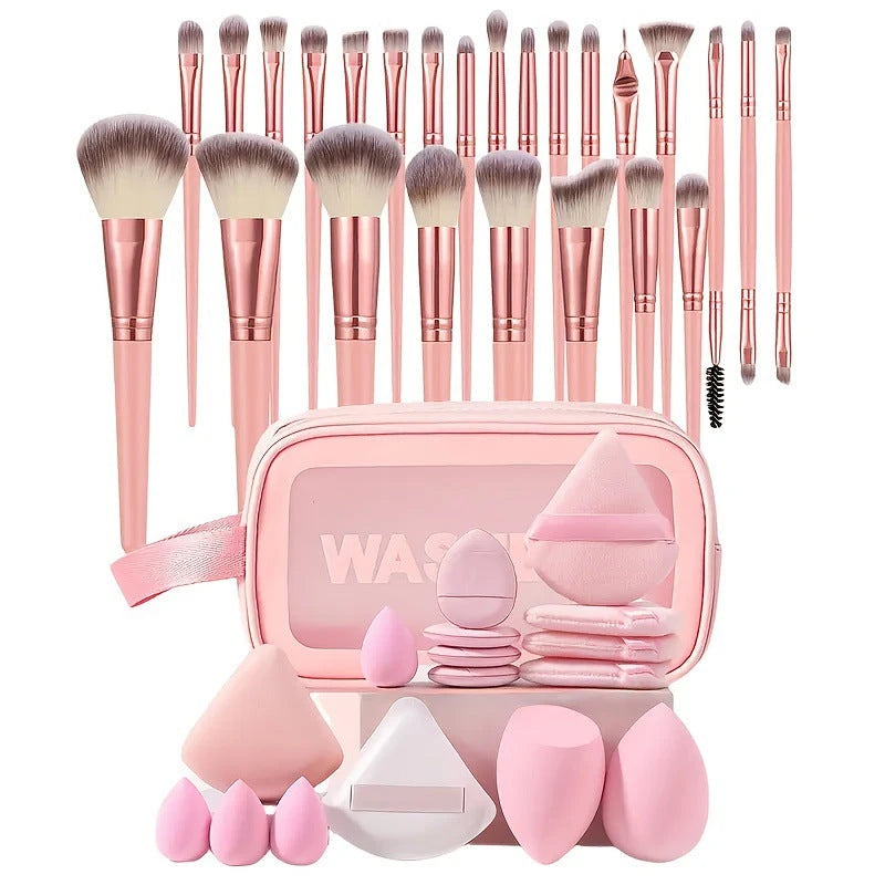 Makeup brush set with pink case and accessories on a white background