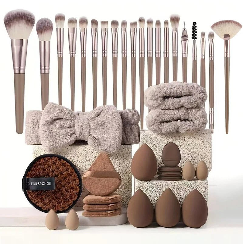 Makeup brushes, sponges, and towels arranged on a white background