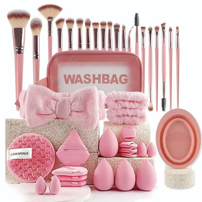 Pink makeup brushes, washbag, and accessories on a white background