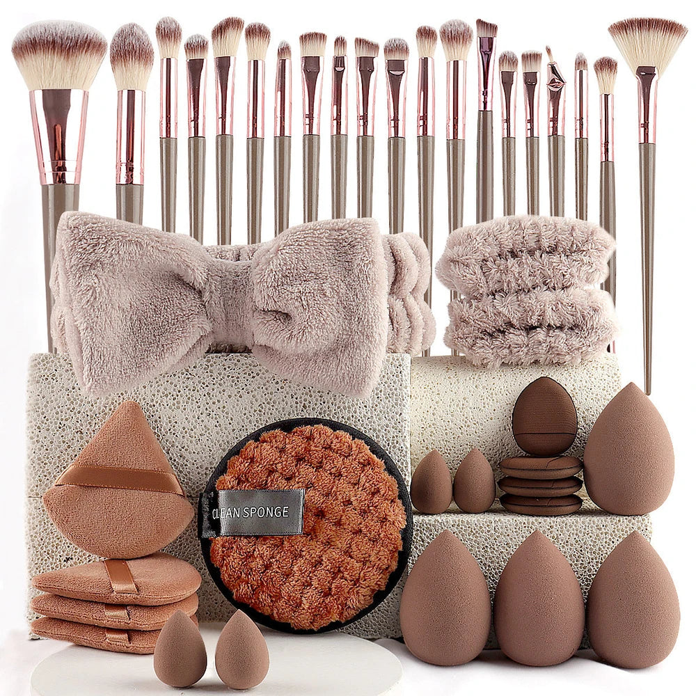 Makeup accessory set with rose gold brushes, brown blending sponges, a soft bow headband, and matching beauty tools.