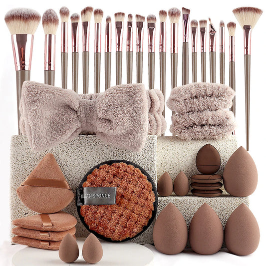 Makeup accessory set with rose gold brushes, brown blending sponges, a soft bow headband, and matching beauty tools.