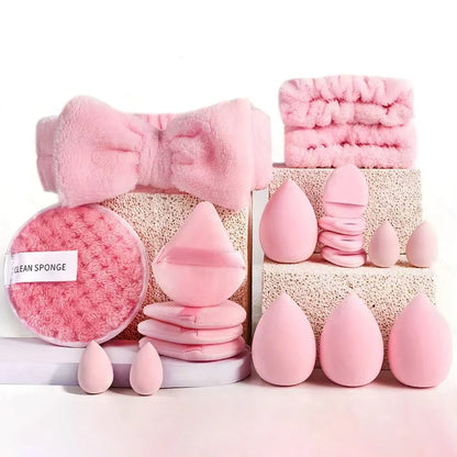 Set of pink makeup sponges and tools on a white background
