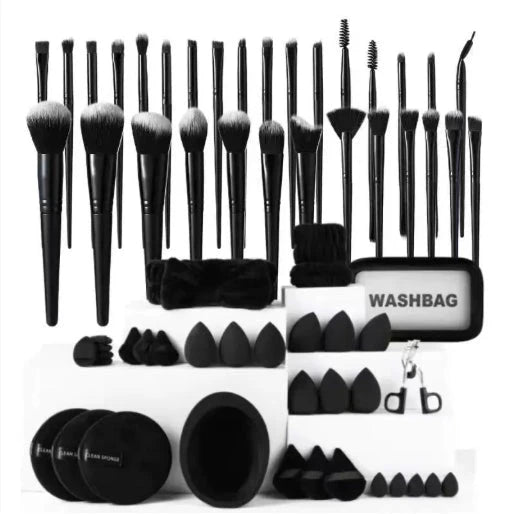 Set of black makeup brushes and accessories with a washbag on a white background