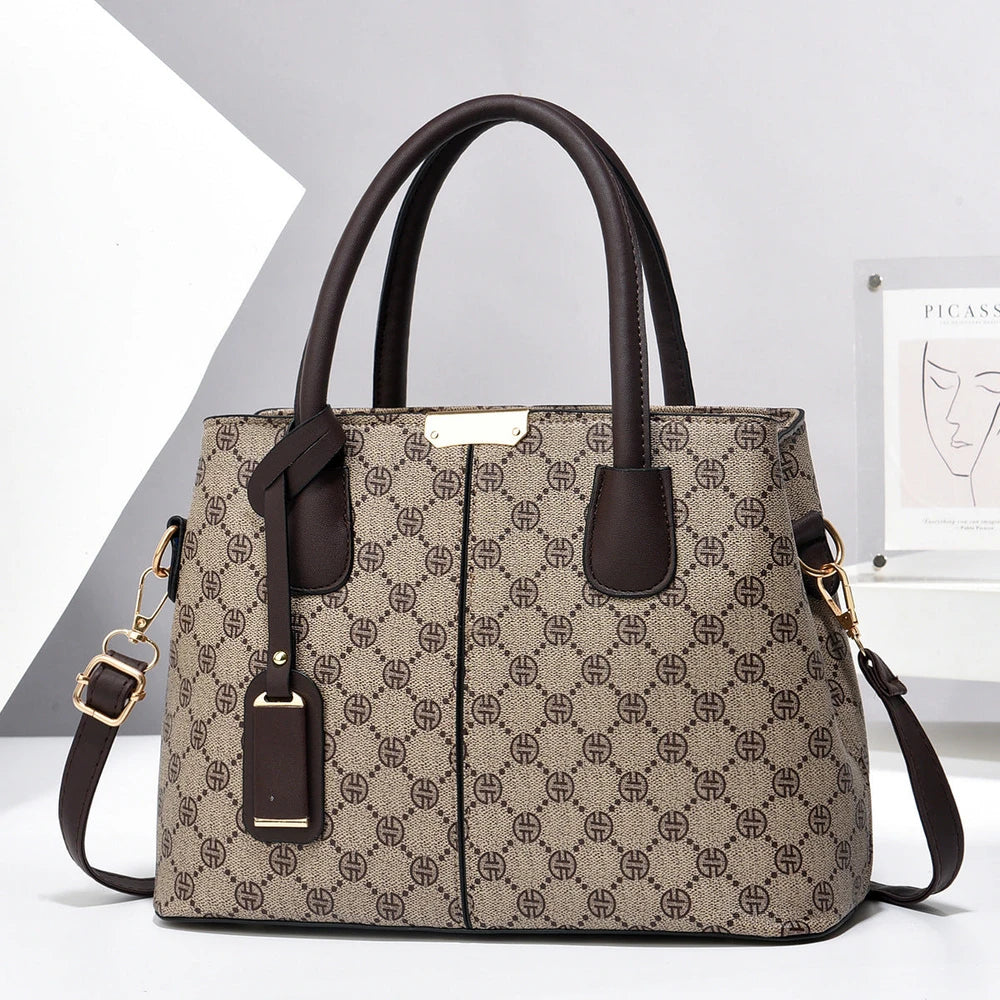 Patterned handbag with brown handles and strap on a white background