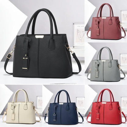 Textured faux leather tote bag with two top handles and a shoulder strap, shown in black, burgundy, gray, cream, navy, and red.