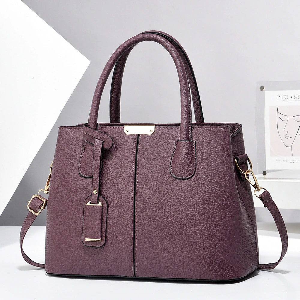 Purple handbag with gold accents on a white background