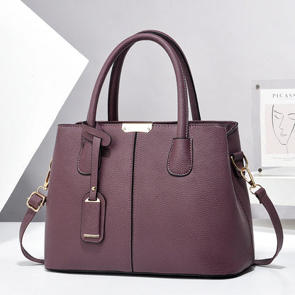 Purple handbag with gold accents on a white background
