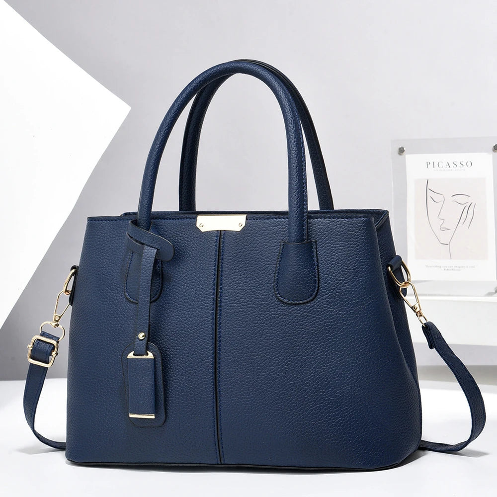 Blue handbag with gold accents on a white background