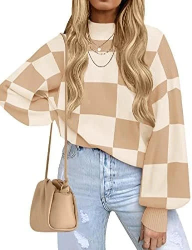Woman wearing a checkered sweater and jeans with a beige handbag on a white background