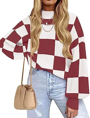 Woman wearing a red and white checkered sweater with a beige handbag on a white background