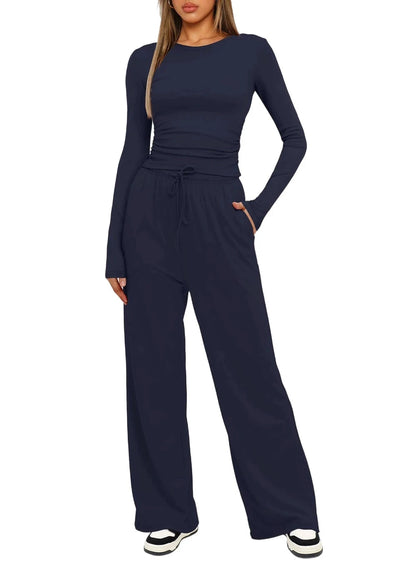 Navy blue jumpsuit worn by a model on a white background