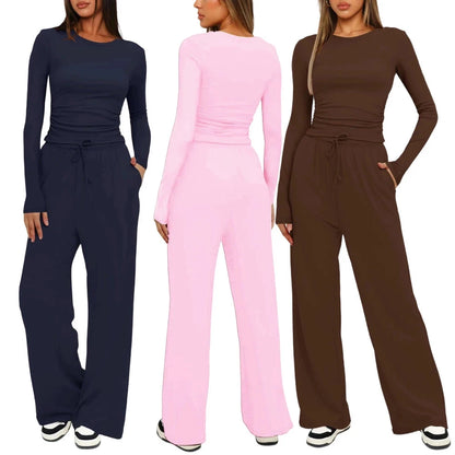 Three women modeling matching long-sleeve jumpsuits in navy blue, light pink, and brown, shown against a plain white background.