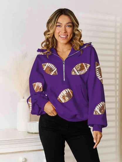 Model wearing a purple quarter-zip hoodie with football graphics on the front and sleeves.