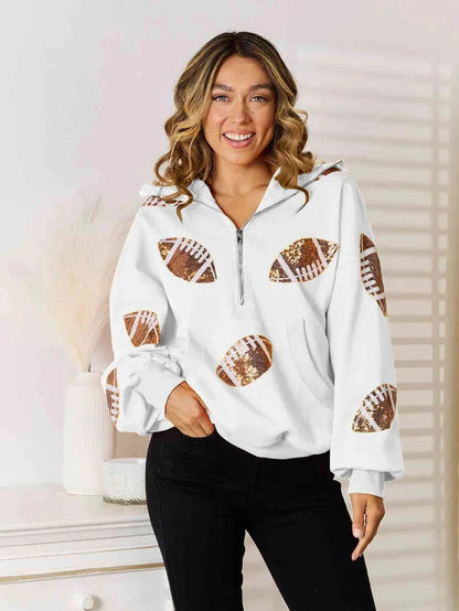 Model wearing a white quarter-zip hoodie with football graphics on the front and sleeves.