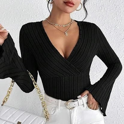 Person wearing a black ribbed long-sleeve top with a white background