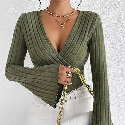 Model wearing an olive green ribbed wrap-style V-neck top with long bell sleeves, styled with white pants.