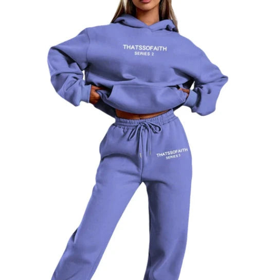 Person wearing a blue hoodie and pants set with 'THATSSOFAITH' text on a white background