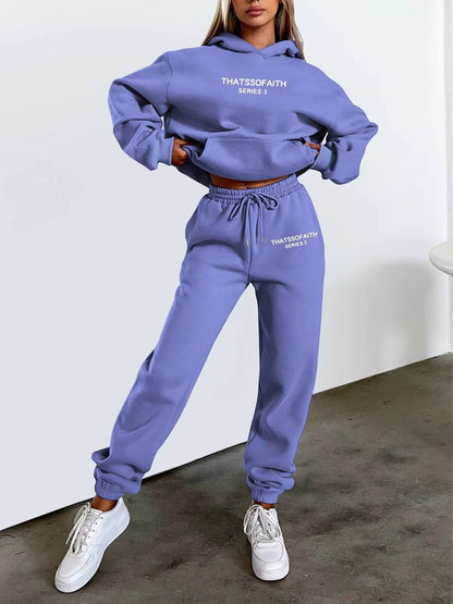 Person wearing a purple sweatshirt and pants set with text on a white background