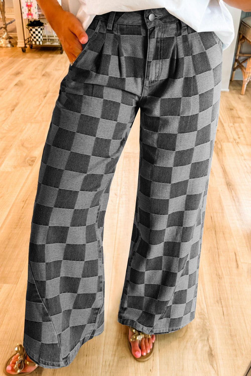Gray checkerboard wide-leg pants styled with a white top and sandals