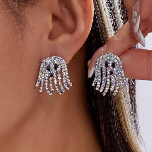 Pair of iridescent rhinestone ghost earrings with black face details and sparkling fringe-style strands.