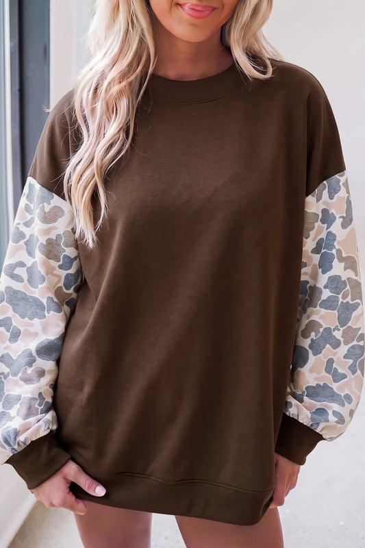 Coffee brown crewneck sweatshirt with camouflage print long sleeves and ribbed cuffs.